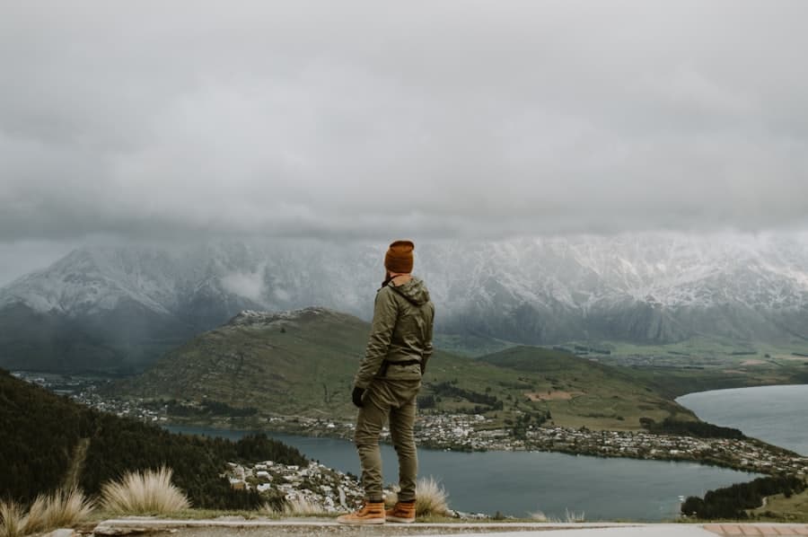 Tramper overlooking Lake Wakatipu under low cloud
