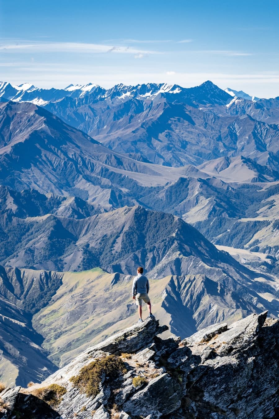 Hiker on a schist ridge above the Wakatipu basin